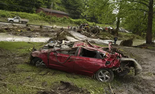 A damaged vehicle sits in flood debris, Monday, June 16, 2025, in Valley Grove, W.Va. (AP Photo/Carolyn Kaster)