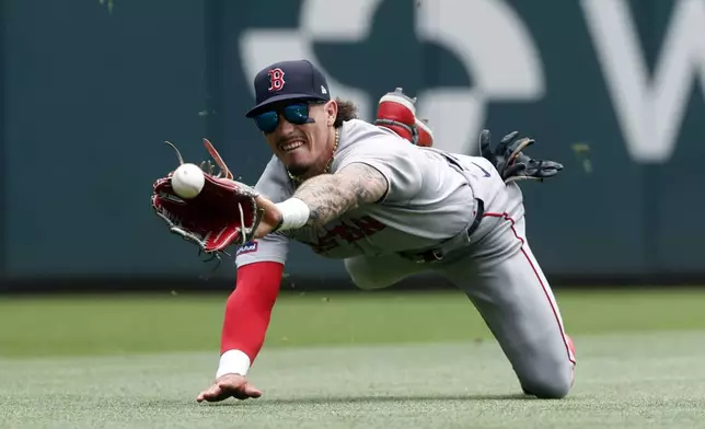 Boston Red Sox outfielder Jarren Duran comes up short as he dives for a line drive by Atlanta Braves' Matt Olson during the fourth inning of a baseball game, Sunday, June 1, 2025, in Atlanta. (AP Photo/Butch Dill)