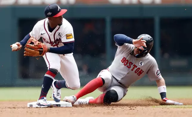 Atlanta Braves second baseman Ozzie Albies (1) gets the force out on Boston Red Sox's Trevor Story (10) as he slides into second base during the fourth inning of a baseball game, Sunday, June 1, 2025, in Atlanta. (AP Photo/Butch Dill)