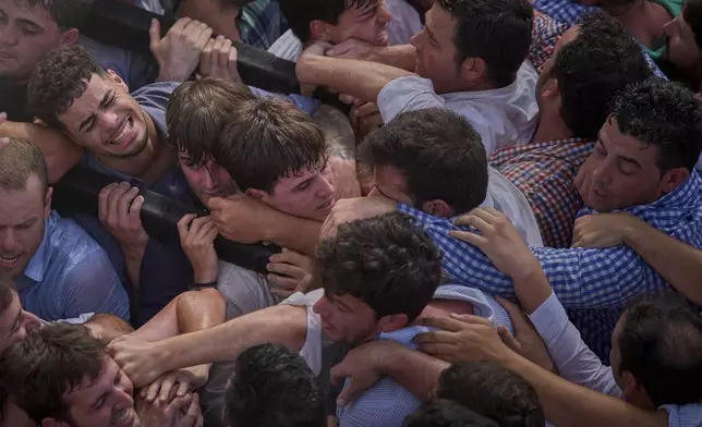 Pilgrims carry the Virgin of El Rocio, during a procession in the village of El Rocio, near Almonte in southern Spain, Monday, June 9, 2025, during the annual pilgrimage in which devotees of the Virgin del Rocio converge on the shrine. (AP Photo/Emilio Morenatti)