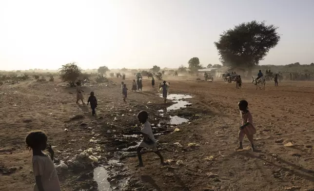 Sudanese children play by the Sudanese border in the Adre, Chad, transit camp, Wednesday , May 7, 2025. (AP Photo/Caitlin Kelly)