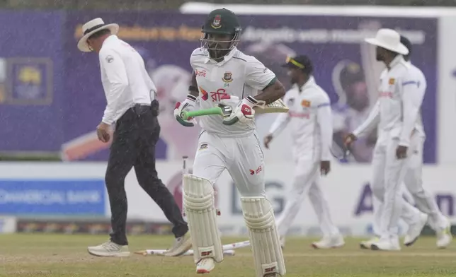 Bangladesh's captain Najmul Hossain Shanto runs towards the pavilion as it rains during the fifth day of the first cricket test match between Sri Lanka and Bangladesh in Galle, Sri Lanka, Saturday, June 21, 2025. (AP Photo/Eranga Jayawardena)