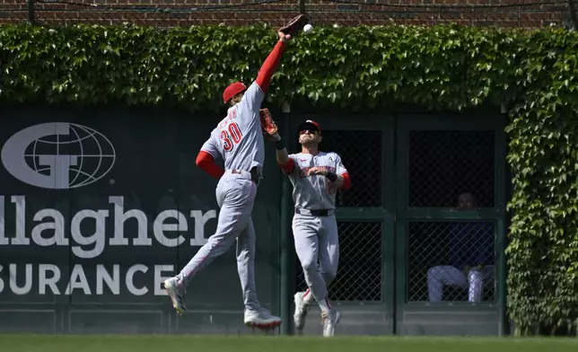 Cincinnati Reds outfielder Will Benson (30) cannot catch a double hit by Chicago Cubs' Pete Crow-Armstrong during the seventh inning of a baseball game, Sunday, June 1, 2025, in Chicago. (AP Photo/Matt Marton)
