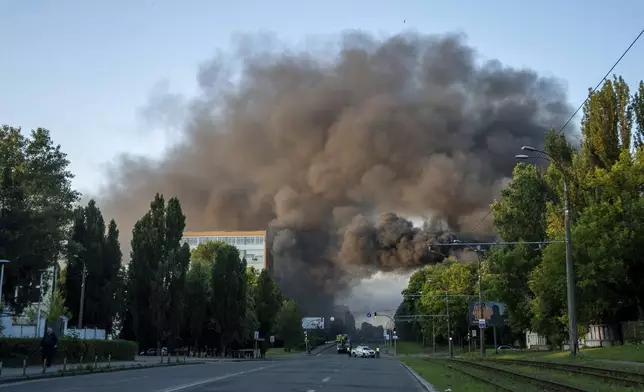 Smoke rising after Russian missile attack, which injured at least 15 people at Kyiv, Ukraine, on Tuesday, June 17, 2025. (AP Photo/Alex Babenko)