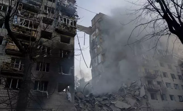 Smoke rising from destroyed house after Russian missile attack, which injured at least 15 people at Kyiv, Ukraine, on Tuesday, June 17, 2025. (AP Photo/Alex Babenko)