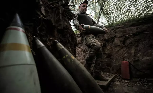 In this photo taken on June 14, 2025 and provided by Ukraine's 24th Mechanized Brigade press service, a serviceman prepares to fire a 155mm M109 howitzer towards Russian army positions near Chasiv Yar, Donetsk region, Ukraine, Saturday, June 14, 2025. (Oleg Petrasiuk/Ukraine's 24th Mechanized Brigade via AP)