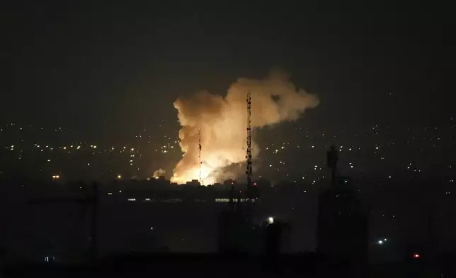 Smoke rises up after an explosion in Tehran, Iran, Friday, June 13, 2025. (AP Photo/Vahid Salemi)