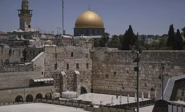 The Western Wall, the holiest site where Jews can pray, stands nearly empty as Israel's Home Front Command banned public gatherings following an Israeli military strike on Iran, in Jerusalem's Old City, Friday, June 13, 2025. (AP Photo/Mahmoud Illean)