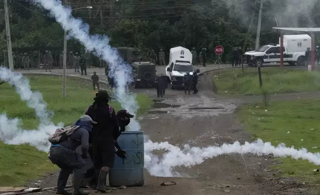 Protesters clash with police during a demonstration against recent actions by President Jose Raul Mulino, including a pension reform law and a security agreement with the United States involving the Panama Canal, in Arimae, Panama, Thursday, June 5, 2025. (AP Photo/Matias Delacroix)