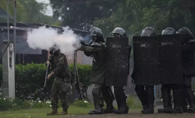 Police fire tear gas at anti-government protesters blocking the Pan-American Highway in the Embera Indigenous community of Arimae, Panama, Thursday, June 5, 2025. (AP Photo/Matias Delacroix)