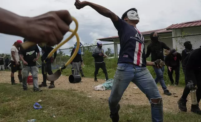 Anti-government protesters clash with police at the Indigenous Embera community of Arimae, Panama, Thursday, June 5, 2025. (AP Photo/Matias Delacroix)