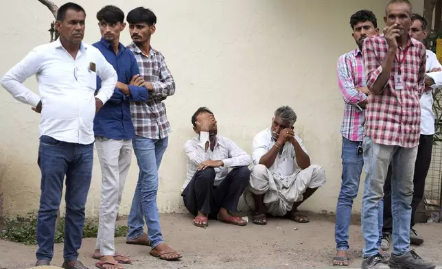 Family members wait at a hospital for the body of a relative killed in an airplane crash on Thursday in Ahmedabad, India, Friday, June 13, 2025. (AP Photo/Ajit Solanki)