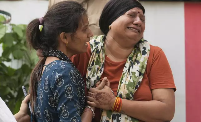 Grieving relatives of Air India plane crash victims mourn outside the autopsy room at a hospital in Ahmedabad, India, Friday, June 13, 2025. (AP Photo/Rafiq Maqbool)