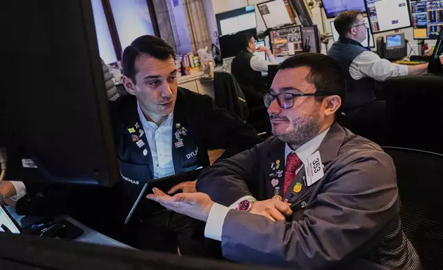 Traders Dylan Halvorsan, left, and Drew Cohen work on the floor of the New York Stock Exchange, Monday, June 9, 2025. (AP Photo/Richard Drew)