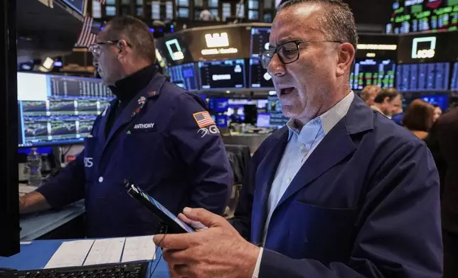 Trader David Fox, right, and specialist Anthony Matesic work on the floor of the New York Stock Exchange, Monday, June 9, 2025. (AP Photo/Richard Drew)
