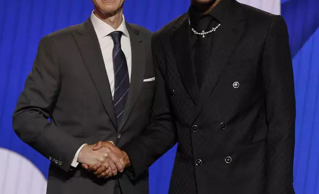 VJ Edgecombe poses for a photo with NBA commissioner Adam Silver after being selected third by the Philadelphia 76ers In the first round of the NBA basketball draft, Wednesday, June 25, 2025, in New York. (AP Photo/Adam Hunger)