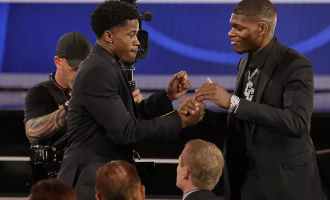 VJ Edgecombe, left, is congratulated by Cedric Coward after being selected third by the Philadelphia 76ers In the first round of the NBA basketball draft, Wednesday, June 25, 2025, in New York. (AP Photo/Adam Hunger)