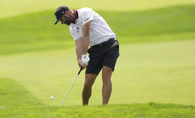 Dustin Johnson hits from the 12th fairway during a practice round ahead of the U.S. Open golf tournament at Oakmont Country Club Tuesday, June 10, 2025, in Oakmont, Pa. (AP Photo/Carolyn Kaster)