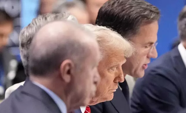 President Donald Trump listens to NATO Secretary General Mark Rutte, right, during a plenary session at the NATO summit in The Hague, Netherlands, Wednesday, June 25, 2025. (AP Photo/Alex Brandon)