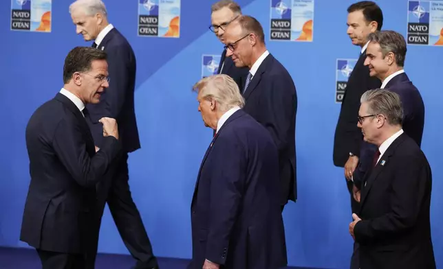 NATO Secretary General Mark Rutte, left, speaks with President Donald Trump, center, and Britain's Prime Minister Keir Starmer, right, after a group photo of NATO heads of state and government at the NATO summit in The Hague, Netherlands, Wednesday, June 25, 2025. (AP Photo/Geert Vanden Wijngaert)