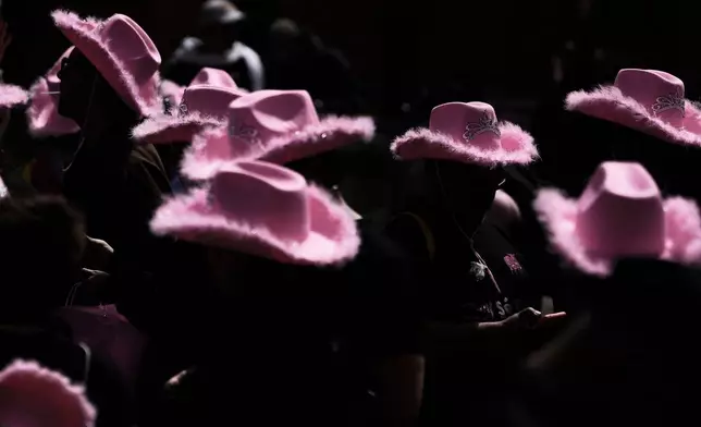 Revelers wear pink hats during the annual Pride parade marking LGBTQ+ Pride month in Bogota, Colombia, Sunday, June 29, 2025. (AP Photo/Ivan Valencia )