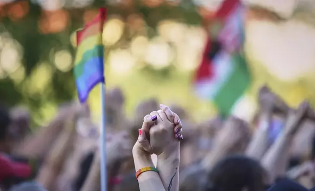 People hold hands during the Pride march in Budapest, Hungary, Saturday, June 28, 2025. (AP Photo/Rudolf Karancsi)