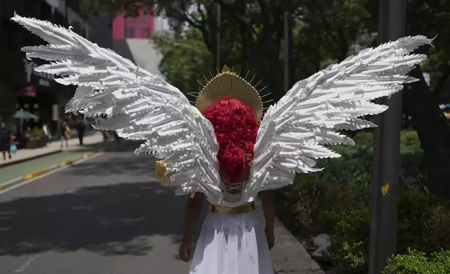 A participant wearing angel wings takes part in the annual Pride march in Mexico City, Saturday, June 28, 2025. (AP Photo/Eduardo Verdugo)