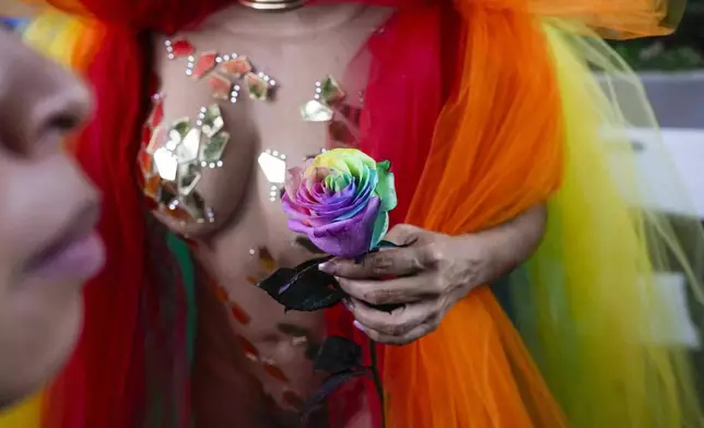 A reveler takes part in a Pride parade marking the culmination of LGBTQ+ Pride month in Panama City, Saturday, June 28, 2025. (AP Photo/Matias Delacroix)