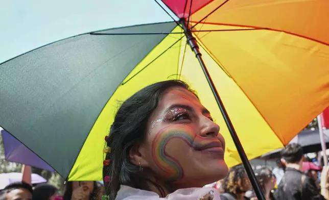 A participant smiles while taking part in a Pride Parade rally in Quito, Ecuador, Saturday, June 28, 2025. (AP Photo/Dolores Ochoa)