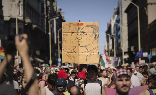 Participant in the Pride march hold a drawing made on a piece of cardboard in Budapest, Hungary, Saturday, June 28, 2025. (AP Photo/Rudolf Karancsi)