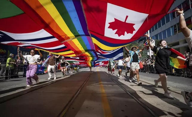 Revelers participate in the Pride Parade on Sunday, June 29, 2025, in Toronto, Canada. (Arlyn McAdorey/The Canadian Press via AP)