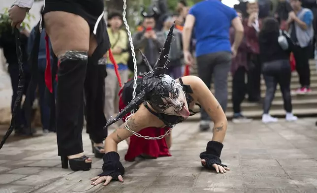 Members of LGTBIQ+ community perform before the start of the Pride March in Asuncion, Paraguay, Saturday, June 28, 2025. (AP Photo/Jorge Saenz)