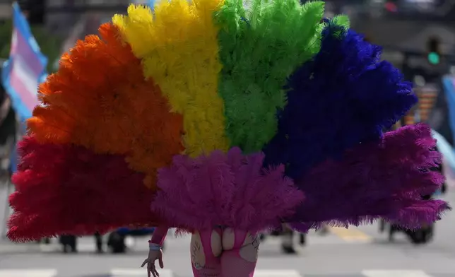 Eryn Keyes walks down Broadway during the Nashville Pride Parade, Saturday, June 28, 2025, in Nashville, Tenn. (AP Photo/George Walker IV)