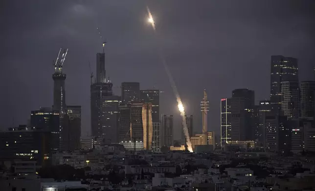 Israel's Iron Dome air defense system fires to intercept projectiles over Tel Aviv, Saturday, June 14, 2025. (AP Photo/Leo Correa)