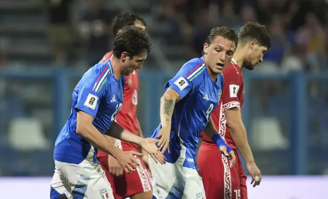 Italy's Andrea Cambiaso, left, celebrates scoring with Mateo Retegui during the World Cup 2026 qualifiers soccer match between Italy and Moldova at the Mapei Stadium, Reggio Emilia, Italy, Monday June 9, 2025. (Massimo Paolone/LaPresse via AP)