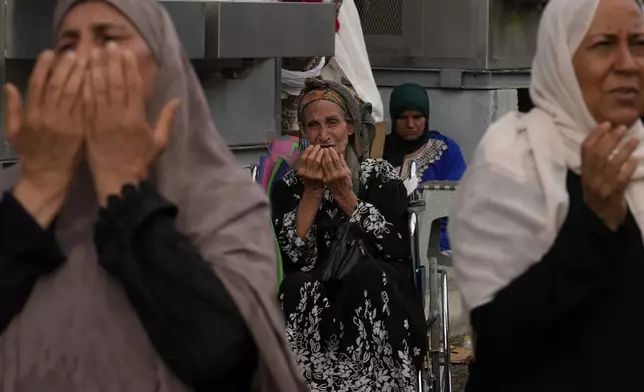 FILE - Muslim pilgrims pray after casting stones at pillars in the symbolic stoning of the devil during the annual hajj, as it rains in Mina, near the holy city of Mecca, Saudi Arabia, Monday, June 17, 2024. (AP Photo/Rafiq Maqbool, File)