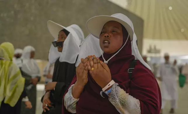 FILE - A pilgrim offer prayers after she cast stones at a pillar in the symbolic stoning of the devil, during the annual Hajj pilgrimage in Mina, near the holy city of Mecca, Saudi Arabia, Tuesday, June 18, 2024. (AP Photo/Rafiq Maqbool, File)