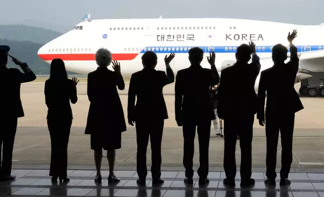 Well-wishers wave to the airplane carrying South Korean President Lee Jae-myung as he departs for Canada to attend the G7 summit, at the Seoul airport in Seongnam, South Korea, Monday, June 16, 2025. (AP Photo/Ahn Young-joon)