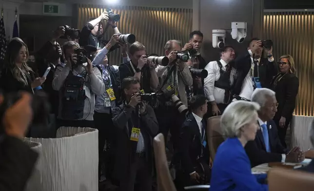 Photographers take photos during a working session at the G7 Summit in Kananaskis, Alberta, Canada, Monday, June 16, 2025. (Darryl Dyck/The Canadian Press via AP)