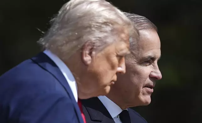 Canadian Prime Minister Mark Carney, back right, directs President Donald Trump off stage after officially welcoming him to the G7 Summit in Kananaskis, Alberta, Canada, Monday, June 16, 2025. (Darryl Dyck/The Canadian Press via AP)