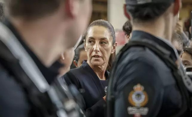 Mexican President Claudia Sheinbaum is swarmed by supporters after arriving in Calgary, Alberta, Monday, June 16, 2025, to attend the G7 Leaders meeting taking place in Kananaskis, Alberta. (Jeff McIntosh/The Canadian Press via AP)