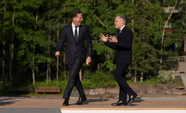 Canadian Prime Minister Mark Carney welcomes NATO secretary-general Mark Rutte to the G7 Summit in Kananaskis, Alberta, Canada, on Tuesday, June 17, 2025. (Darryl Dyck/The Canadian Press via AP)