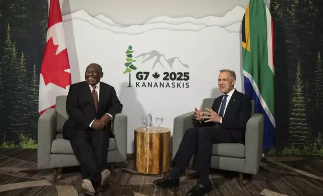 Canadian Prime Minister Mark Carney, right, meets with President of the Republic of South Africa Cyril Ramaphosa, left, as the G7 gets under way in Calgary, Alberta, Sunday, June 15, 2025. (Jason Franson/The Canadian Press via AP)