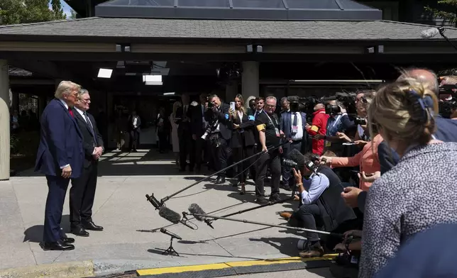 Britain's Prime Minister Keir Starmer, second left, and U.S. President Donald Trump speak to the media at the G7 summit, in Kananaskis, Alberta, Monday, June 16, 2025. (Suzanne Plunkett/Pool Photo via AP)