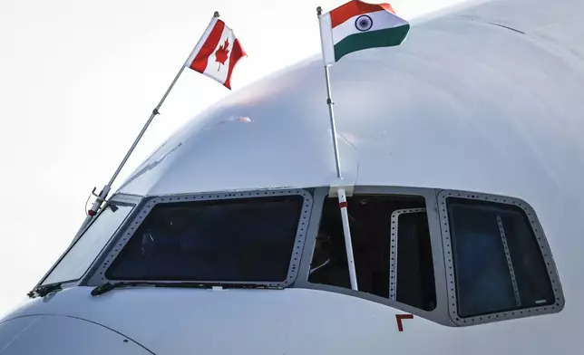 Canadian and Indian flags fly from the cockpit of Indian Prime Minister Narendra Modi's plane as he arrives in Calgary, Alberta, Monday, June 16, 2025, to attend the G7 Leaders meeting taking place in Kananaskis. (Jeff McIntosh/The Canadian Press via AP)