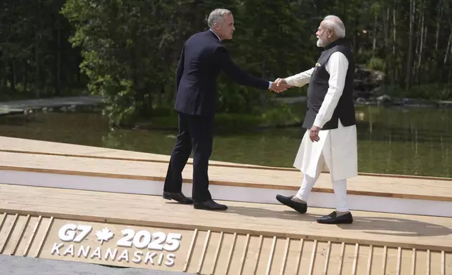 Canadian Prime Minister Mark Carney welcomes Indian Prime Minister Narendra Modi to the G7 Summit in Kananaskis, Alberta, Canada, on Tuesday, June 17, 2025. (Darryl Dyck/The Canadian Press via AP)