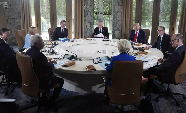 Japan's Prime Minister Shigeru Ishiba, from left, Italy's Prime Minister Giorgia Meloni, France's President Emmanuel Macron, Canada's Prime Minister Mark Carney, President Donald Trump, Britain's Prime Minister Keir Starmer, Germany's Chancellor Friedrich Merz, and in foreground left, European Council President Antonio Costa and foreground right, European Commission President Ursula von der Leyen, participate in a session of the G7 Summit, Monday, June 16, 2025, in Kananaskis, Canada. (AP Photo/Mark Schiefelbein)