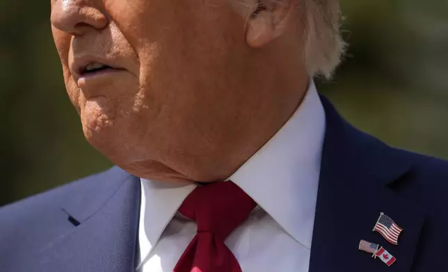 President Donald Trump wears a Canada and U.S. flag pin, as meets with Britain's Prime Minister Keir Starmer on the sidelines of the G7 Summit, Monday, June 16, 2025, in Kananaskis, Canada. (AP Photo/Mark Schiefelbein)