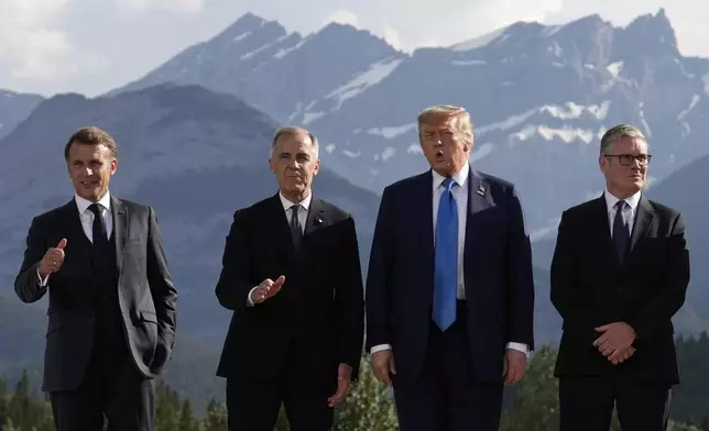 France's President Emmanuel Macron, Canada's Prime Minister Mark Carney, President Donald Trump and Britain's Prime Minister Keir Starmer, arrive for a group photo at the G7 Summit, Monday, June 16, 2025, in Kananaskis, Canada. (AP Photo/Mark Schiefelbein)