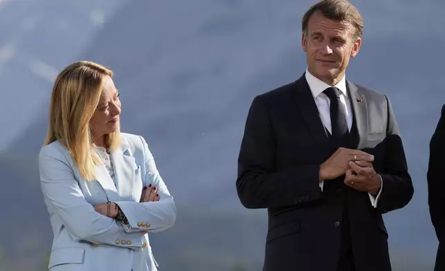 Italy's Prime Minister Giorgia Meloni and France's President Emmanuel Macron listen as President Donald Trump answers questions during a group photo at the G7 Summit, Monday, June 16, 2025, in Kananaskis, Canada. (AP Photo/Mark Schiefelbein)
